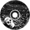 a scan of the CD itself. printed on it is a black and white photograph of a human skull lying on the ground. The word ‘THEY’ is written on its forehead in black capital letters.